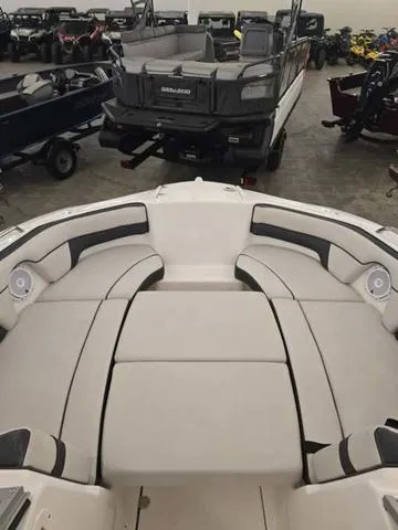 Slide: The Image of 2015 Yamaha AR210 boat interior with spacious seating in a showroom. - 15