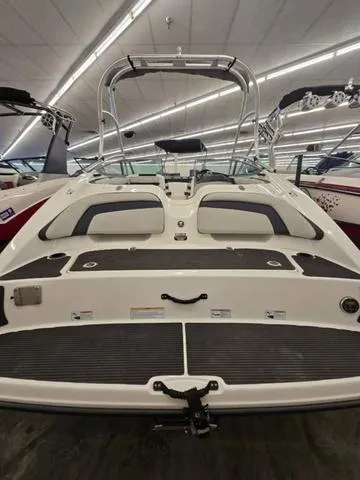 Slide: The Image of 2015 Yamaha AR210 boat, rear view, in showroom with sleek design and modern features. - 4