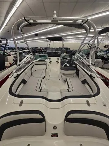 Slide: The Image of 2015 Yamaha AR210 boat interior with sleek seating and modern dashboard. - 5