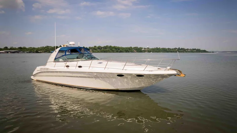 Slide: The Image of 1998 Sea Ray Sundancer 400 yacht on calm water under a clear sky. - 10