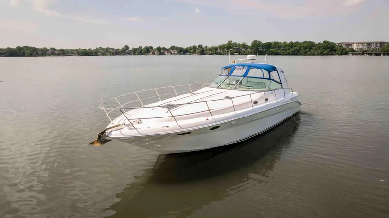 Slide: The Image of 1998 Sea Ray Sundancer 400 yacht on calm water with blue canopy. - 15