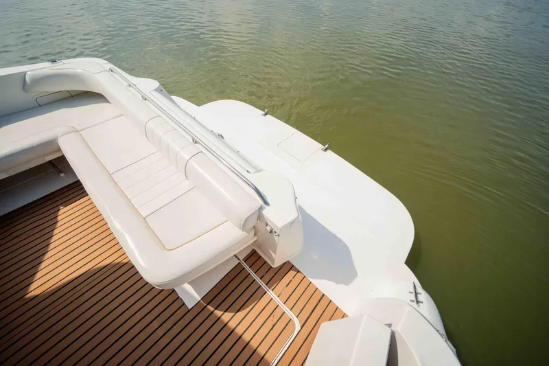 Slide: The Image of 1998 Sea Ray Sundancer 400 boat with teak deck and white seating, on calm water. - 20