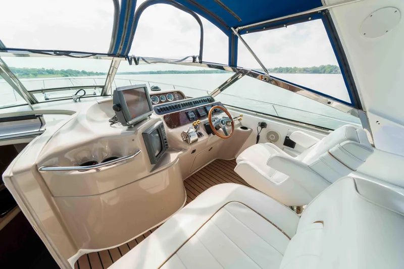 Slide: The Image of 1998 Sea Ray Sundancer 400 yacht cockpit with modern controls and leather seating. - 25