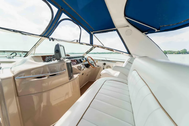Slide: The Image of 1998 Sea Ray Sundancer 400 interior with blue canopy and white seating, showcasing luxury design. - 27