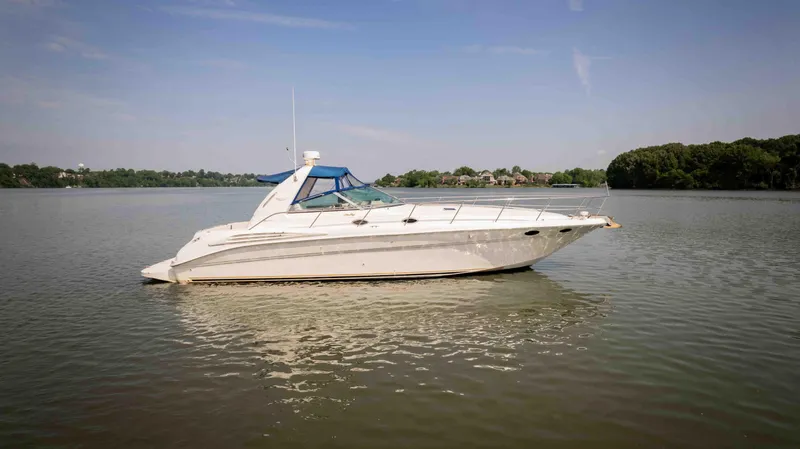 Slide: The Image of 1998 Sea Ray Sundancer 400 yacht on calm water under clear sky. - 31