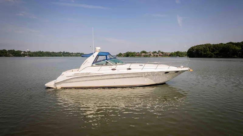 Slide: The Image of 1998 Sea Ray Sundancer 400 yacht on calm water under clear sky. - 32