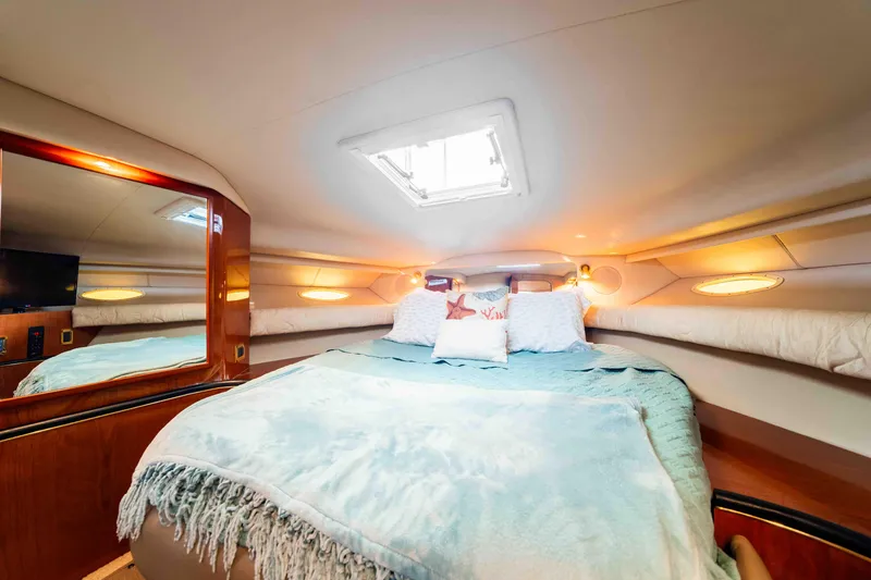 Slide: The Image of Cozy cabin interior of 1998 Sea Ray Sundancer 400 yacht with plush bedding and ambient lighting. - 33