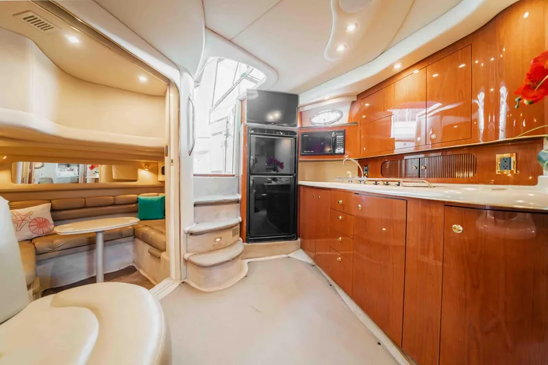 Slide: The Image of Luxurious interior of a 1998 Sea Ray Sundancer 400 yacht with modern kitchen and seating area. - 40