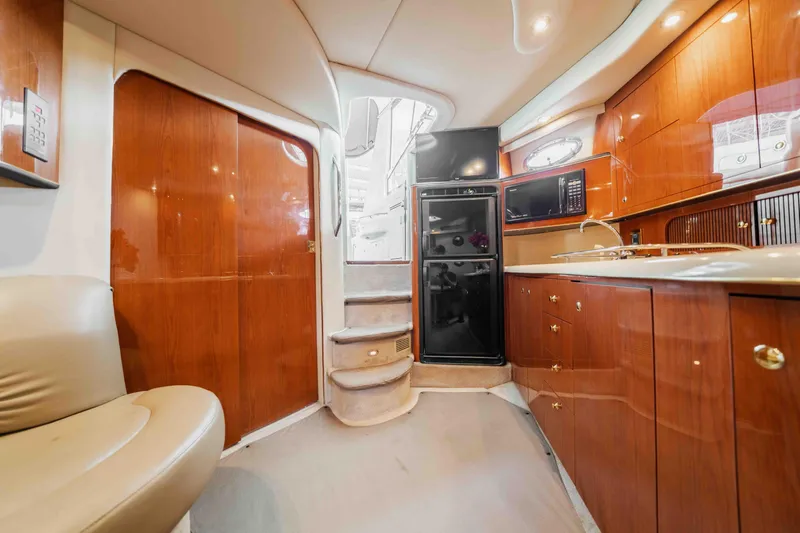 Slide: The Image of Interior of 1998 Sea Ray Sundancer 400 yacht with wooden cabinetry and modern amenities. - 44