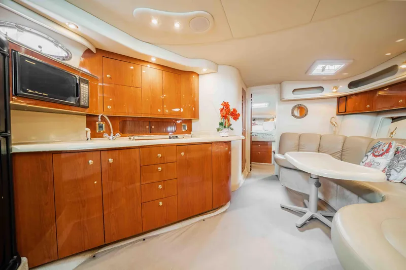 Slide: The Image of Luxurious interior of 1998 Sea Ray Sundancer 400 yacht with elegant wood cabinetry and seating. - 48