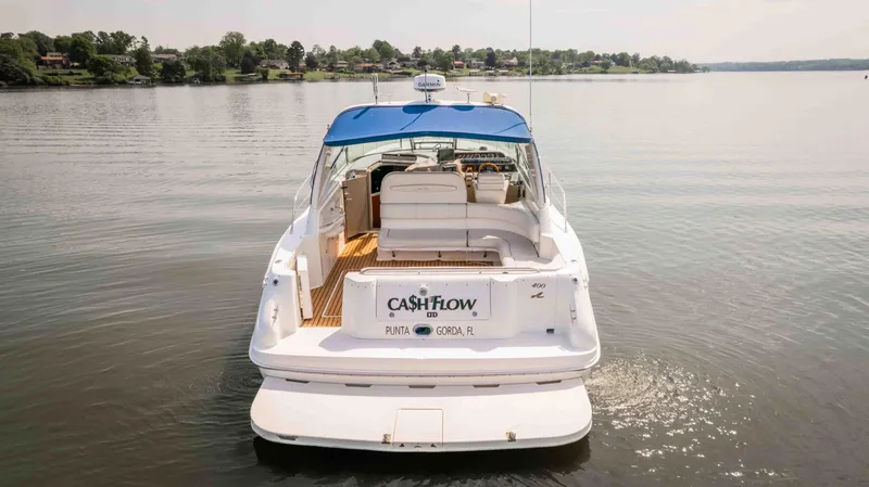 Slide: The Image of 1998 Sea Ray Sundancer 400 yacht with blue canopy on calm water. - 5
