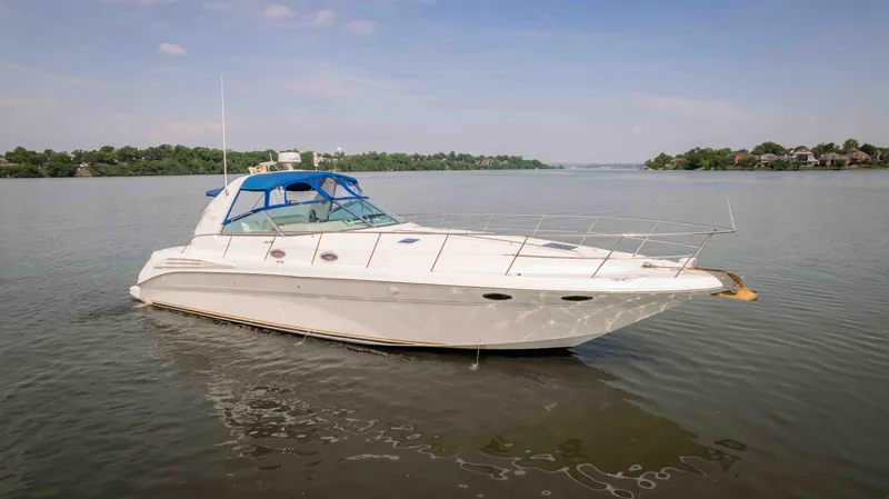 Slide: The Image of 1998 Sea Ray Sundancer 400 yacht on calm water, clear sky, distant shoreline. - 7