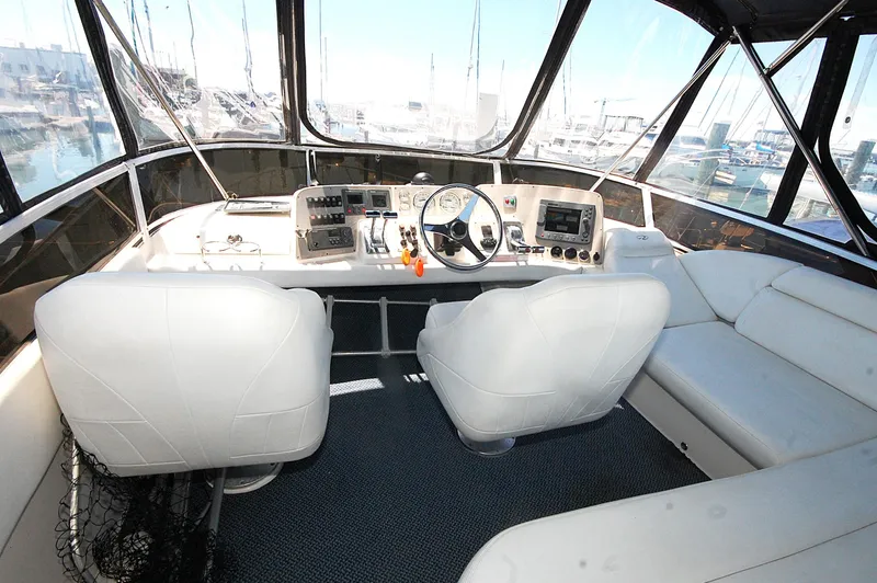 Slide: The Image of 2005 Regal Commodore 3880 yacht cockpit with white seating and navigation controls. - 10