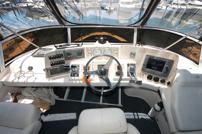 Slide: The Image of 2005 Regal Commodore 3880 helm with steering wheel, gauges, and navigation equipment. - 11