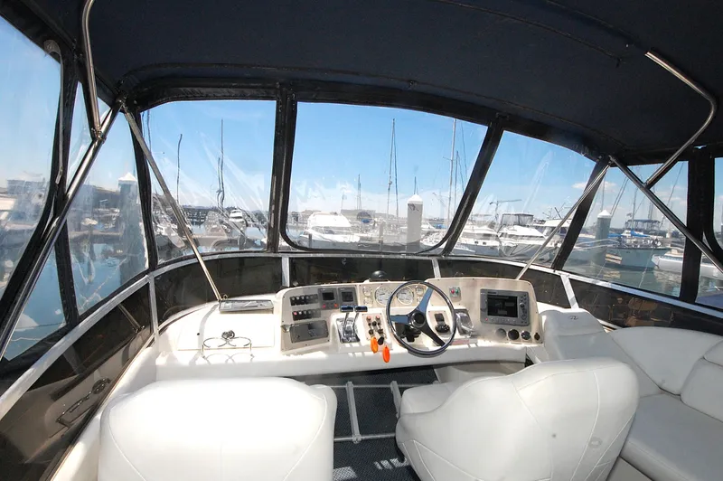 Slide: The Image of 2005 Regal Commodore 3880 yacht cockpit with steering wheel and navigation controls. - 12