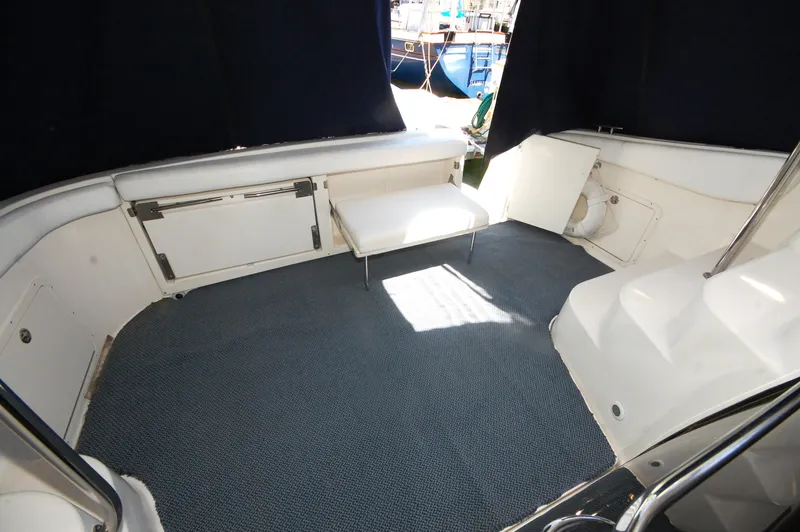 Slide: The Image of 2005 Regal Commodore 3880 yacht interior with seating and carpeted floor. - 16