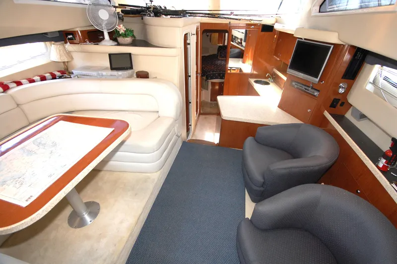 Slide: The Image of Interior of 2005 Regal Commodore 3880 yacht with seating, table, and entertainment area. - 18