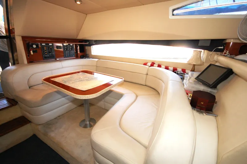 Slide: The Image of Luxurious interior of 2005 Regal Commodore 3880 yacht with plush seating and elegant table. - 19