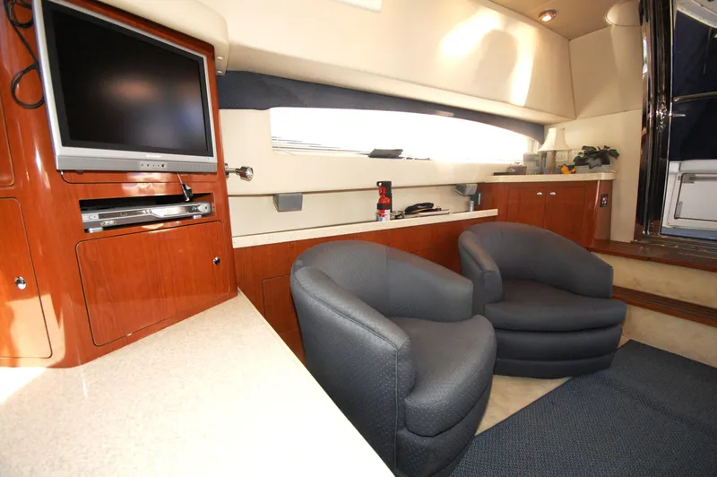 Slide: The Image of Interior of 2005 Regal Commodore 3880 yacht with TV, seating, and wooden cabinetry. - 20