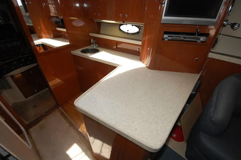 Slide: The Image of 2005 Regal Commodore 3880 yacht interior with kitchenette and TV. - 23