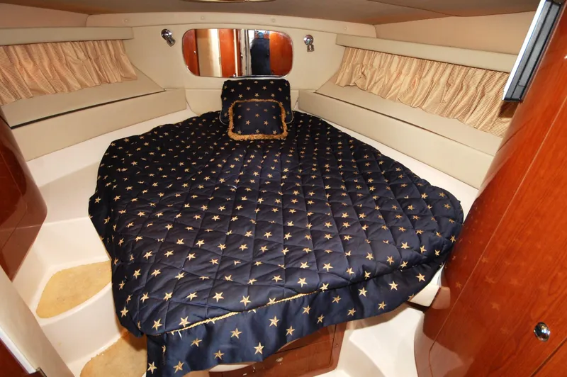 Slide: The Image of Luxurious cabin interior of 2005 Regal Commodore 3880 yacht with star-patterned bedding. - 25