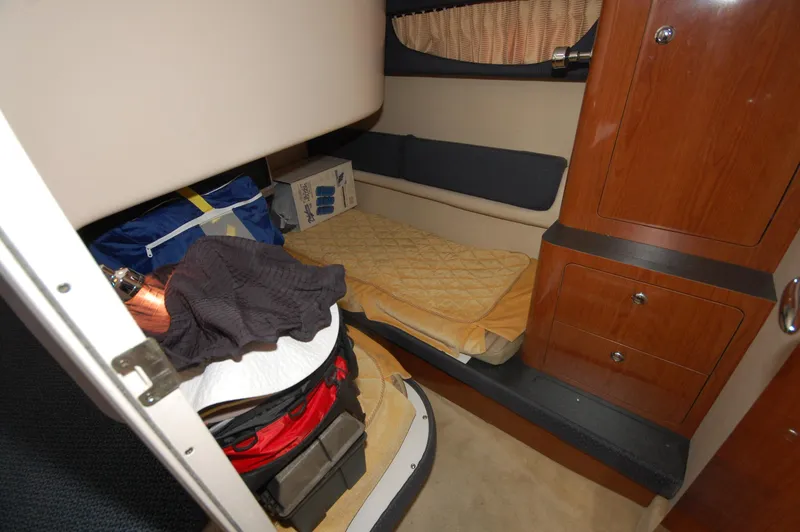 Slide: The Image of 2005 Regal Commodore 3880 cabin interior with storage and bedding. - 26