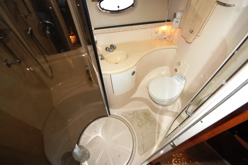 Slide: The Image of 2005 Regal Commodore 3880 yacht bathroom with shower, sink, and toilet. - 27