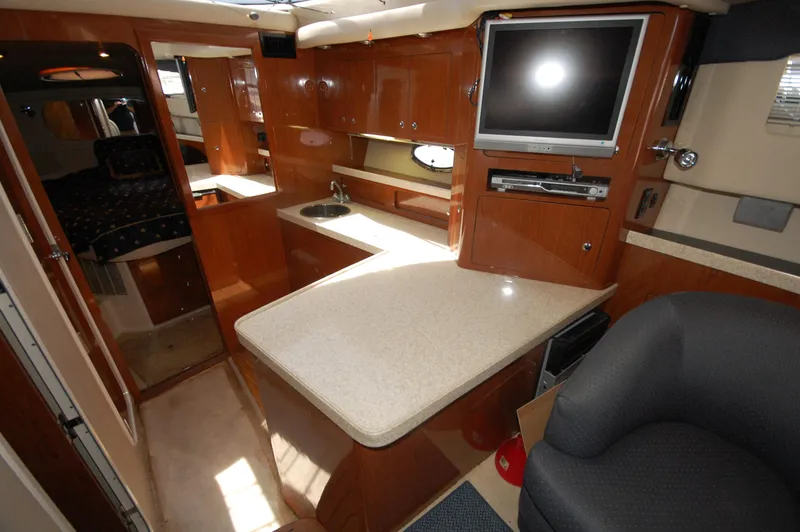 Slide: The Image of Interior of 2005 Regal Commodore 3880 yacht with modern kitchen and entertainment area. - 28