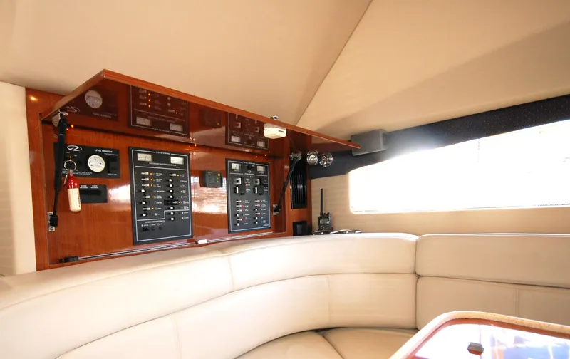 Slide: The Image of 2005 Regal Commodore 3880 yacht interior with control panel and beige seating. - 29