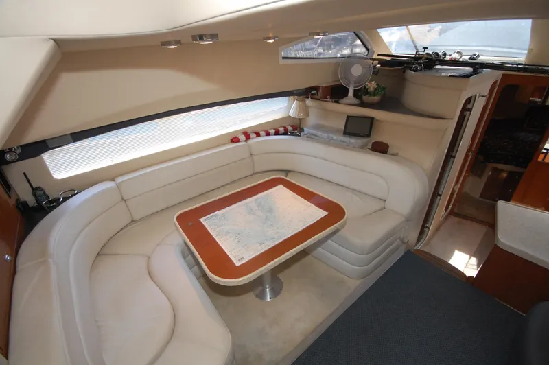 Slide: The Image of 2005 Regal Commodore 3880 yacht interior with plush seating and a central table. - 30
