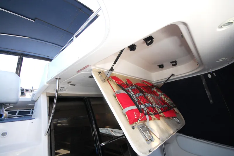 Slide: The Image of Storage compartment with life jackets on a 2005 Regal Commodore 3880 boat. - 32
