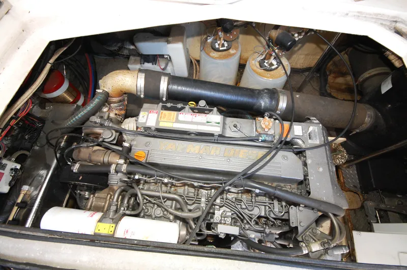 Slide: The Image of Engine compartment of 2005 Regal Commodore 3880 boat, showcasing mechanical components and filters. - 35
