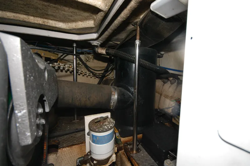 Slide: The Image of Engine compartment of 2005 Regal Commodore 3880 boat, showing mechanical components and piping. - 36