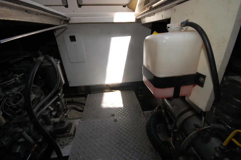 Slide: The Image of Engine room of 2005 Regal Commodore 3880 yacht, featuring mechanical components and storage tank. - 37