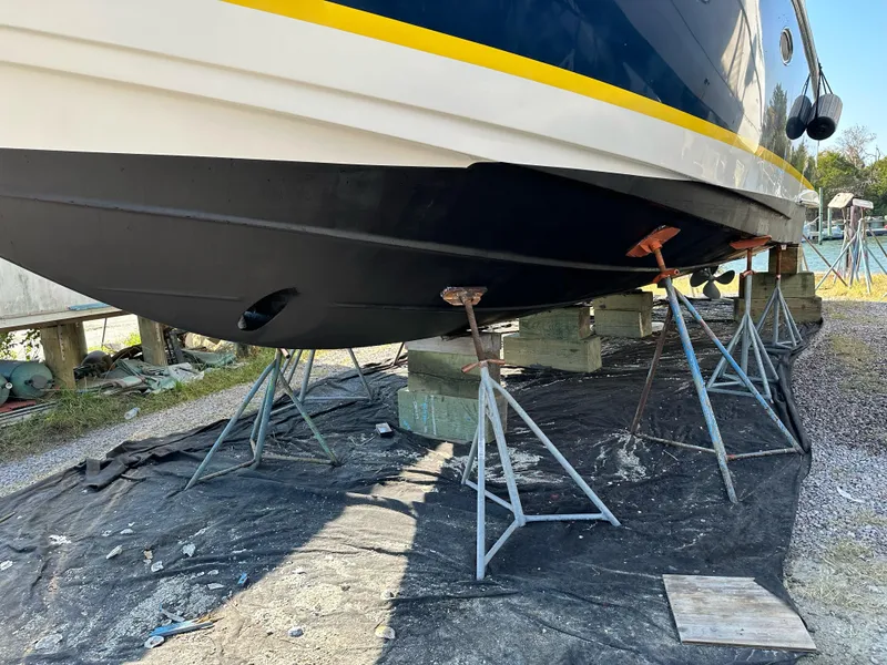 Slide: The Image of 2005 Regal Commodore 3880 boat on stands, hull maintenance underway. - 41