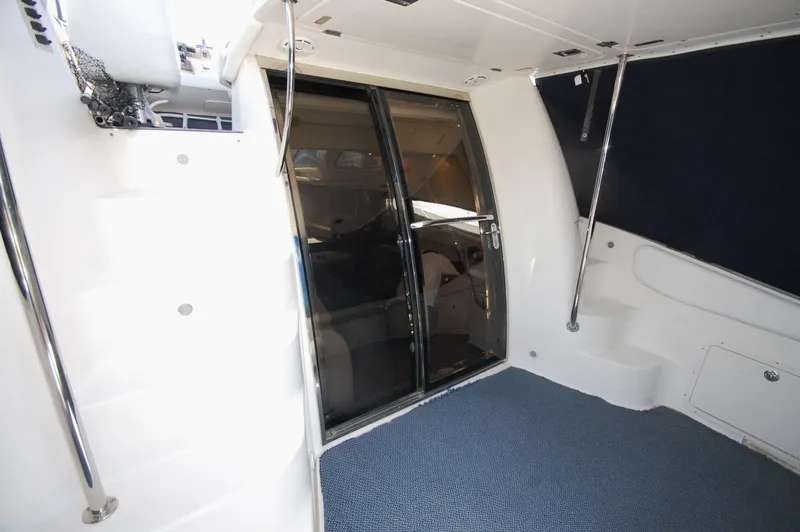 Slide: The Image of 2005 Regal Commodore 3880 yacht interior with sliding glass doors and blue carpet. - 9