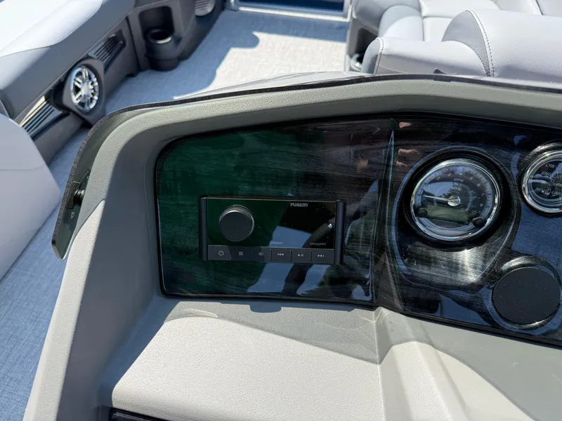 Slide: The Image of 2025 Avalon LSZ Cruise Bench dashboard with stereo and gauges in a luxury boat interior. - 19