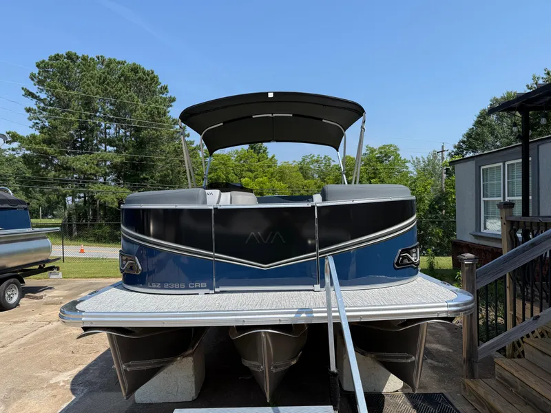 Slide: The Image of 2025 Avalon LSZ Cruise Bench pontoon boat on display outdoors. - 2