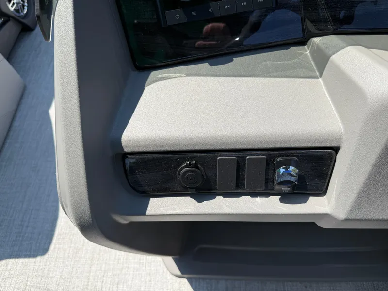 Slide: The Image of Control panel of 2025 Avalon LSZ Cruise Bench boat, featuring switches and a knob. - 20