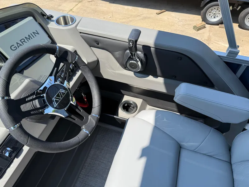 Slide: The Image of 2025 Avalon LSZ Cruise Bench boat interior with steering wheel and Garmin navigation system. - 22