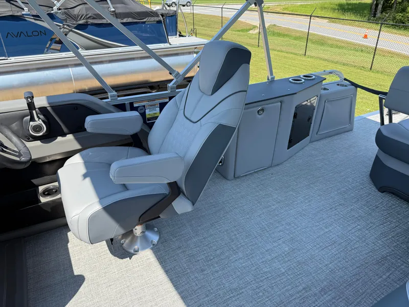 Slide: The Image of 2025 Avalon LSZ Cruise Bench boat interior with captain's chair and control panel. - 28