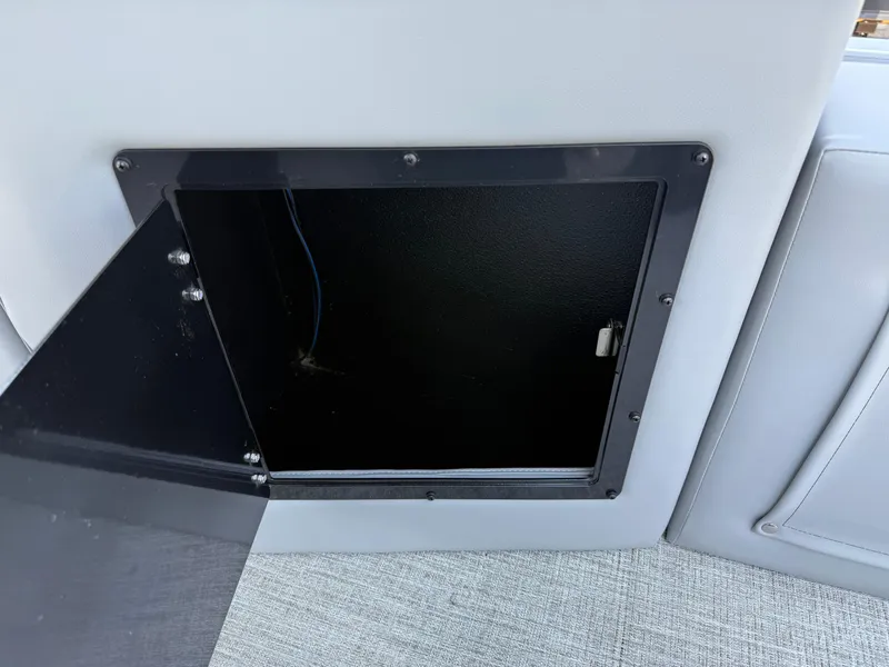Slide: The Image of Open storage compartment in 2025 Avalon LSZ Cruise Bench boat. - 30
