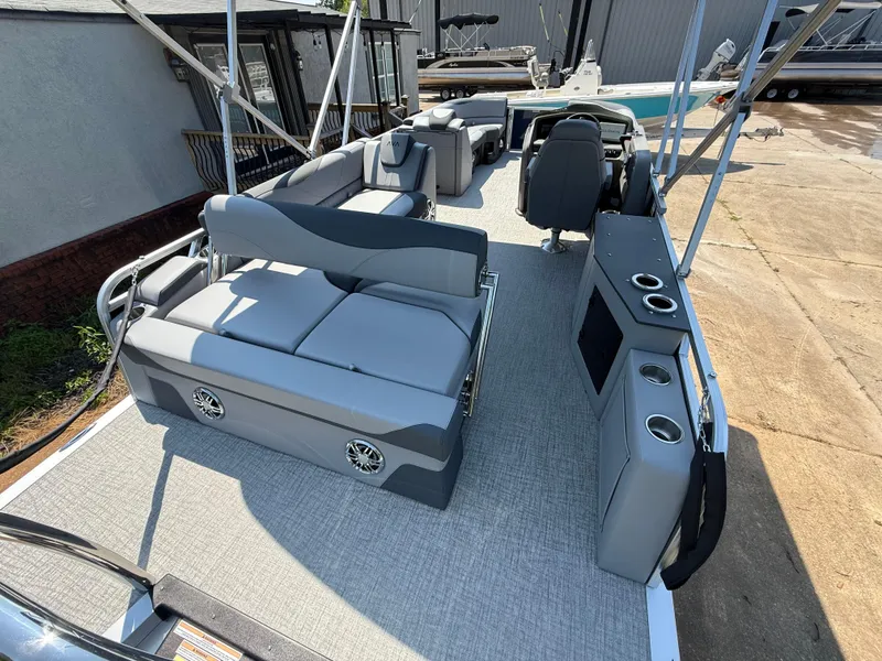 Slide: The Image of 2025 Avalon LSZ Cruise Bench pontoon boat interior with gray seating and cup holders. - 38
