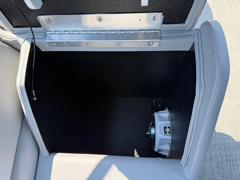 Slide: The Image of Open storage compartment in 2025 Avalon LSZ Cruise Bench with visible speaker inside. - 40