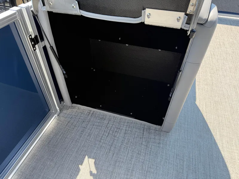 Slide: The Image of Open storage compartment on 2025 Avalon LSZ Cruise Bench boat. - 42