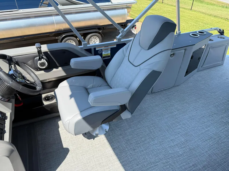 Slide: The Image of 2025 Avalon LSZ Cruise Bench boat interior with luxurious captain's chair and steering console. - 46