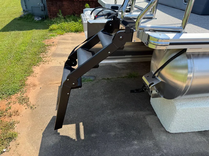 Slide: The Image of 2025 Avalon LSZ Cruise Bench boat with extended boarding ladder on concrete surface. - 48