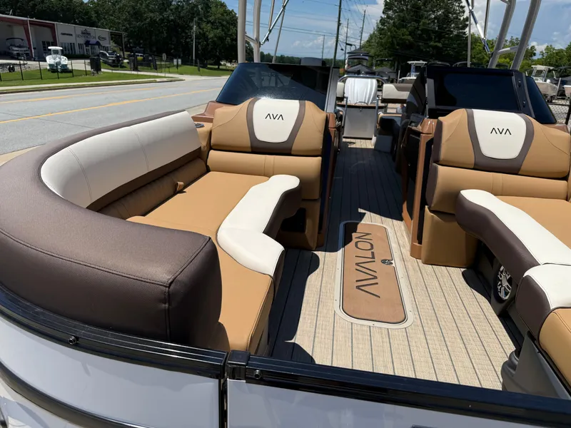 Slide: The Image of 2025 Avalon Catalina Quad Lounger Windshield boat with luxurious seating and sleek design. - 15