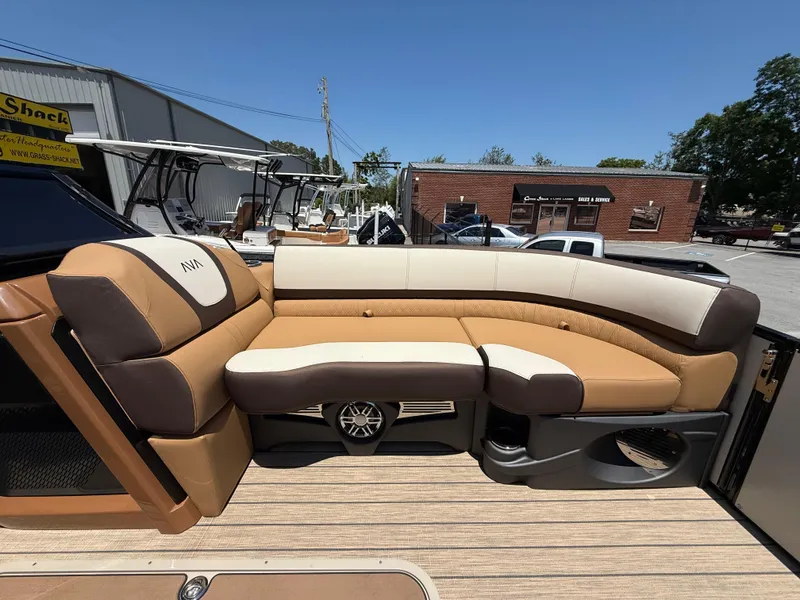Slide: The Image of 2025 Avalon Catalina Quad Lounger Windshield with luxurious tan seating on a sunny day. - 16