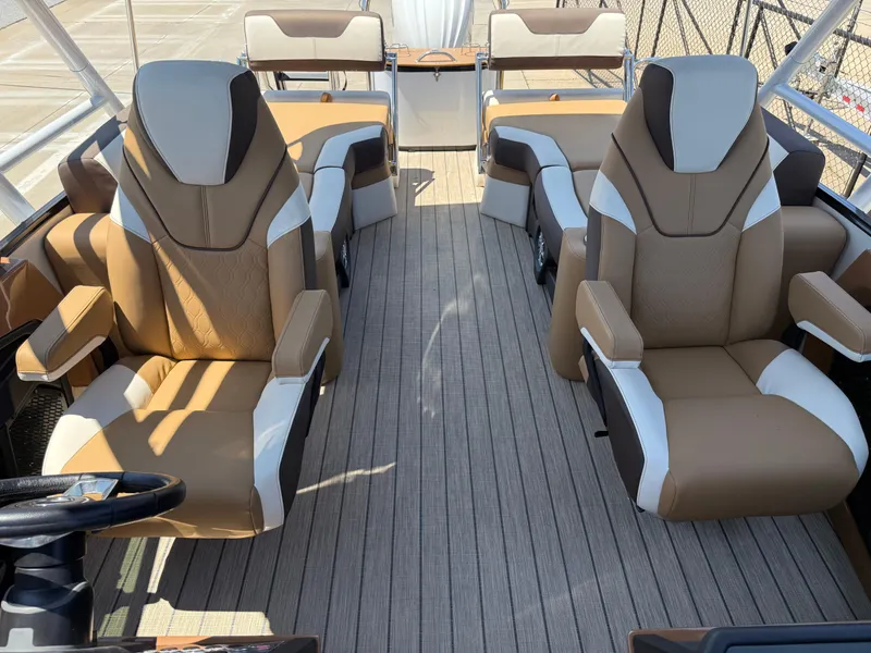 Slide: The Image of 2025 Avalon Catalina Quad Lounger Windshield interior with luxurious tan and white seating. - 20